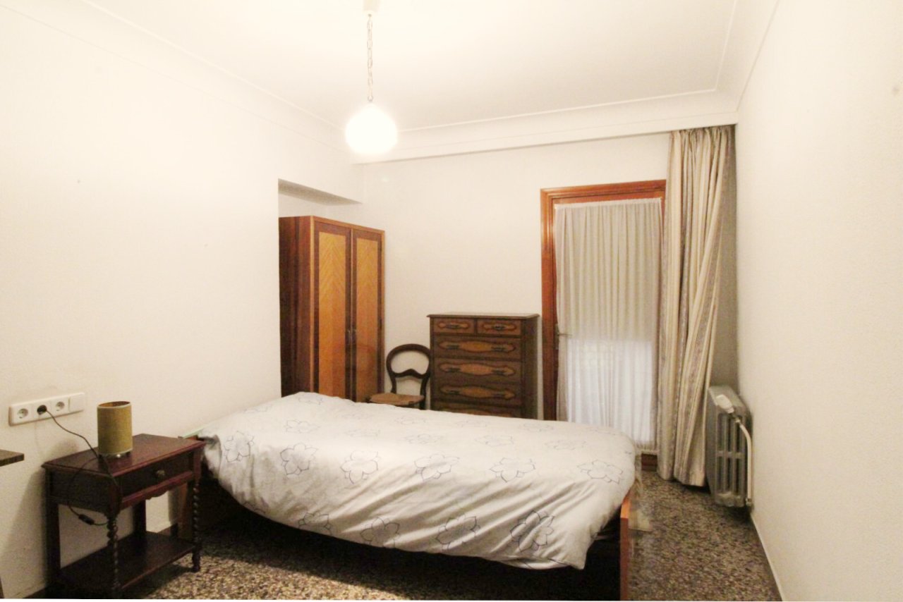 Bedroom with window front and practical storage solutions Bedroom with window front and practical storage solutions