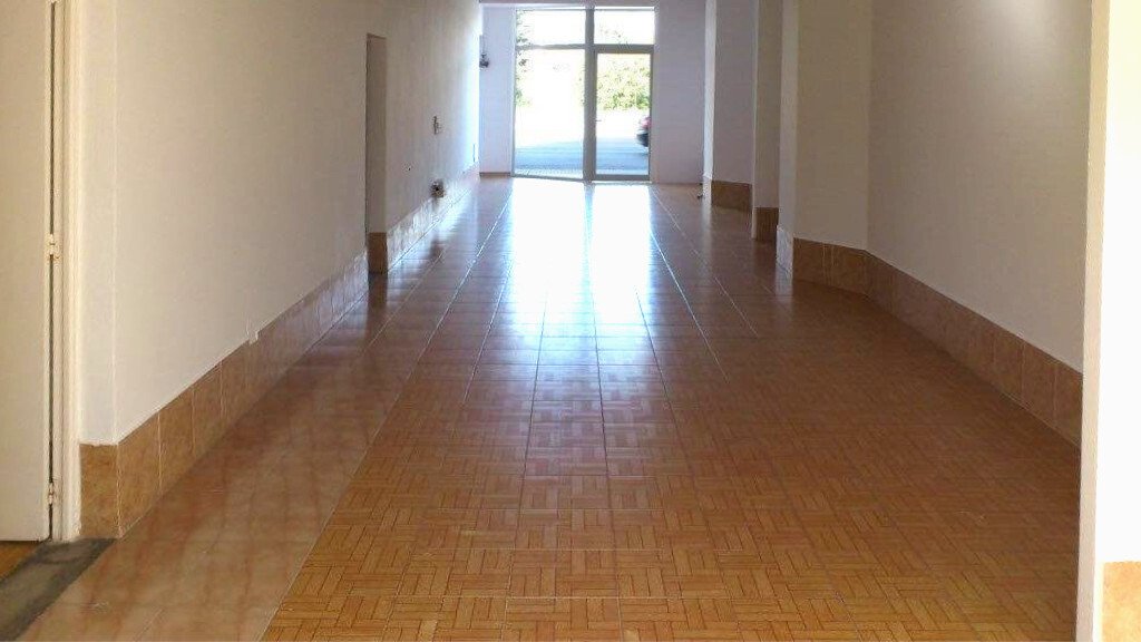 Bright corridor with glass doors, natural light, and direct outdoor access Bright corridor with glass doors, natural light, and direct outdoor access
