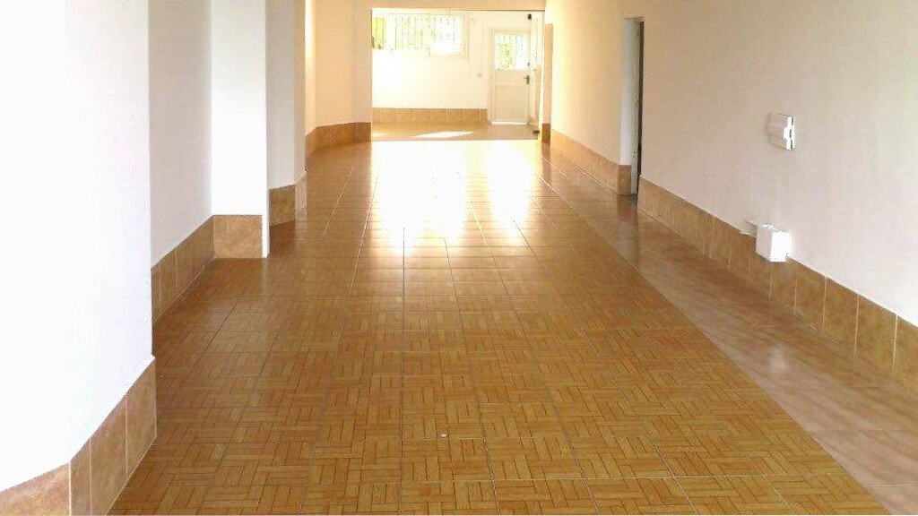 Bright corridor with open pathway and natural light access Bright corridor with open pathway and natural light access