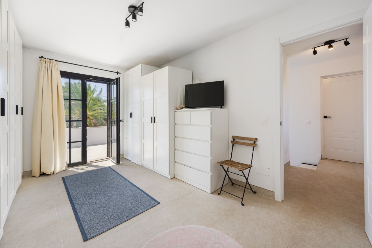 Bright bedroom with direct balcony access and extensive wardrobe system Bright bedroom with direct balcony access and extensive wardrobe system