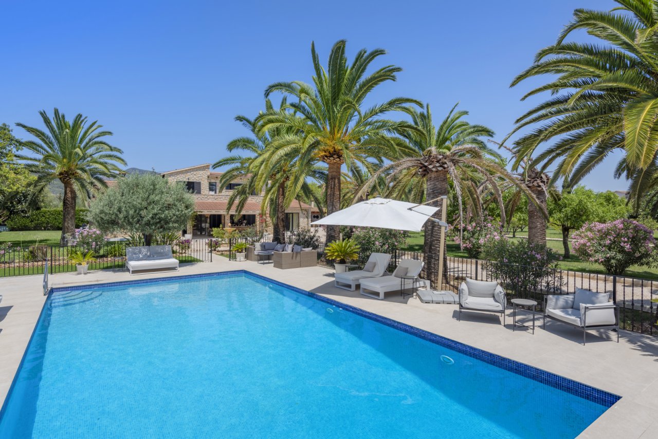 Luxurious pool area with a large terrace and sun protection Luxurious pool area with a large terrace and sun protection