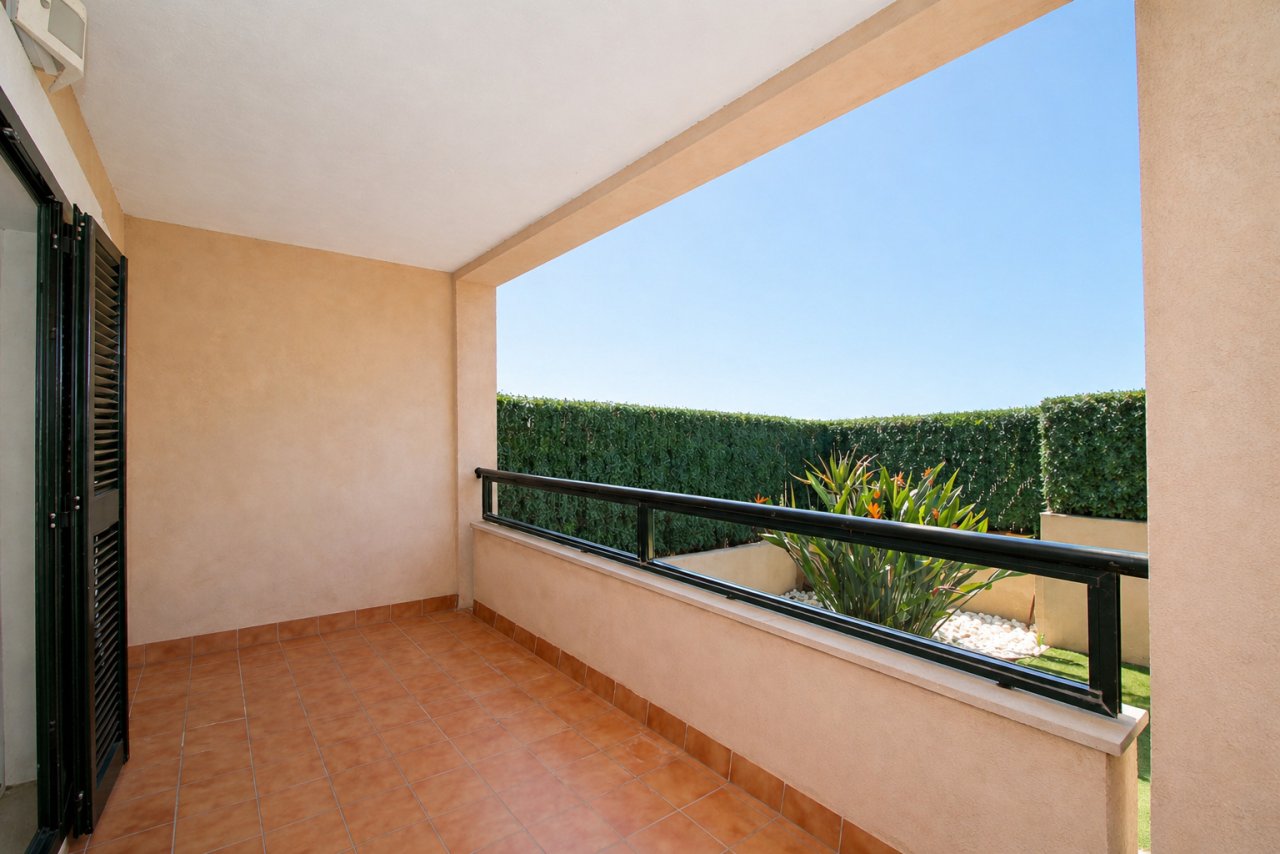 Covered terrace with an open view of the greenery and a spacious seating area