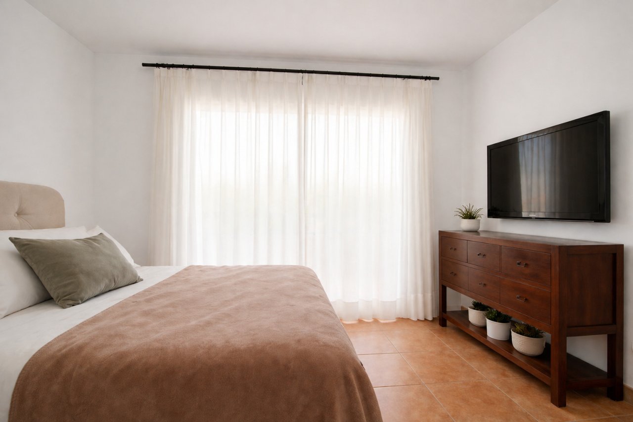 Bright bedroom with direct terrace access and spacious lighting.