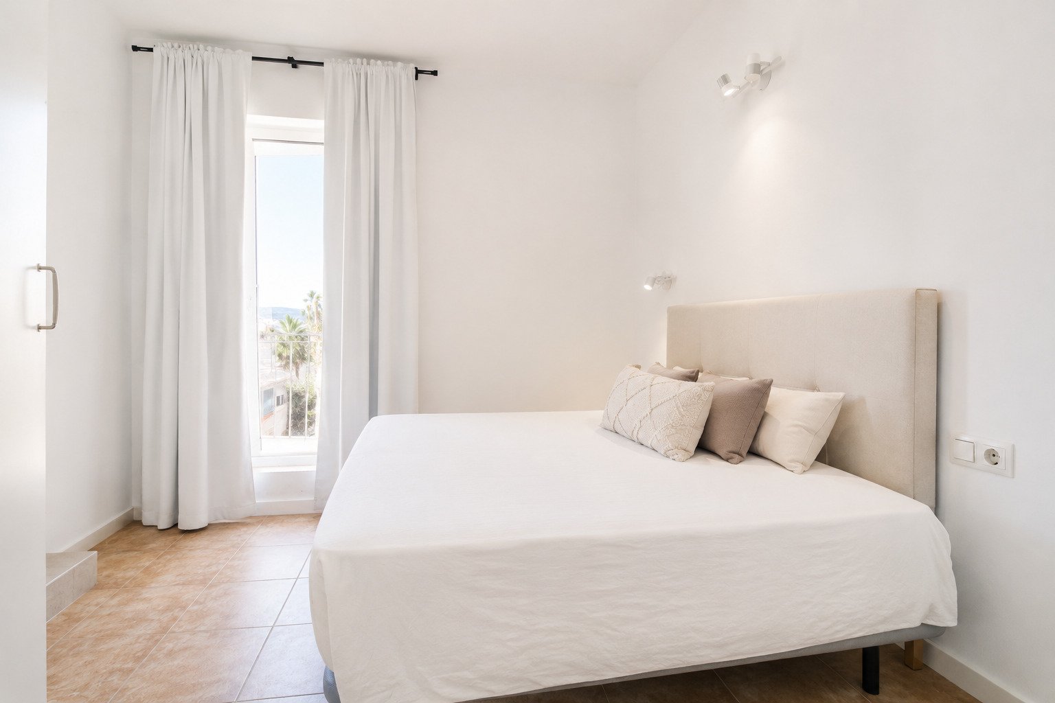 Bright bedroom with balcony access and modern amenities