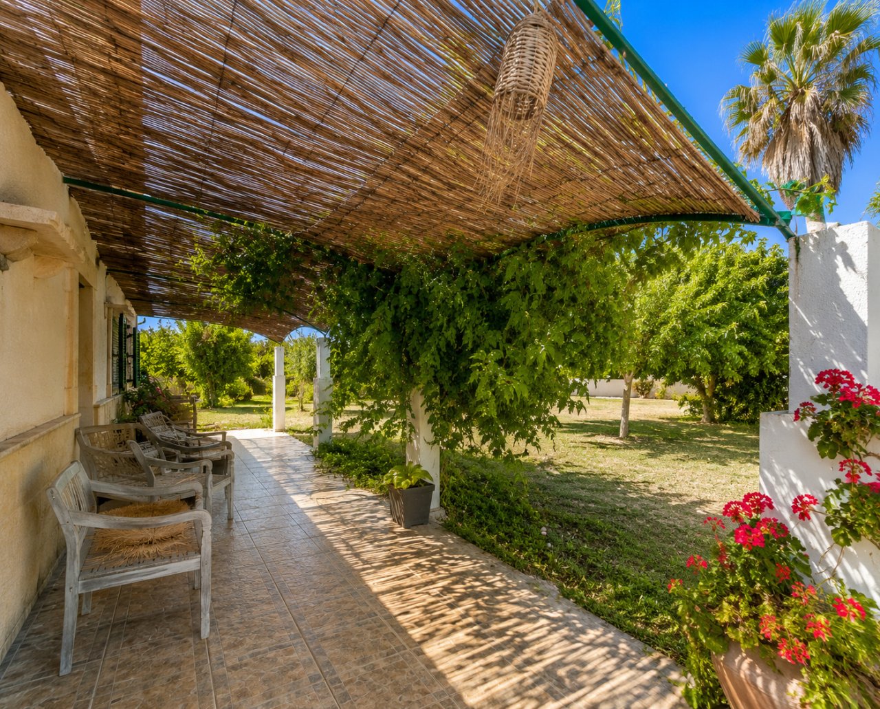 Shaded pergola with durable natural stone paving – an ideal retreat for warm days