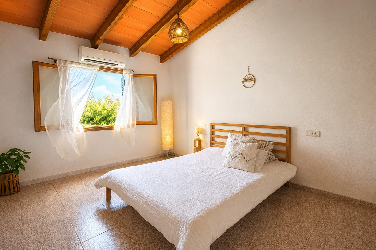 Airy bedroom with a distinctive wooden beam ceiling and air conditioning