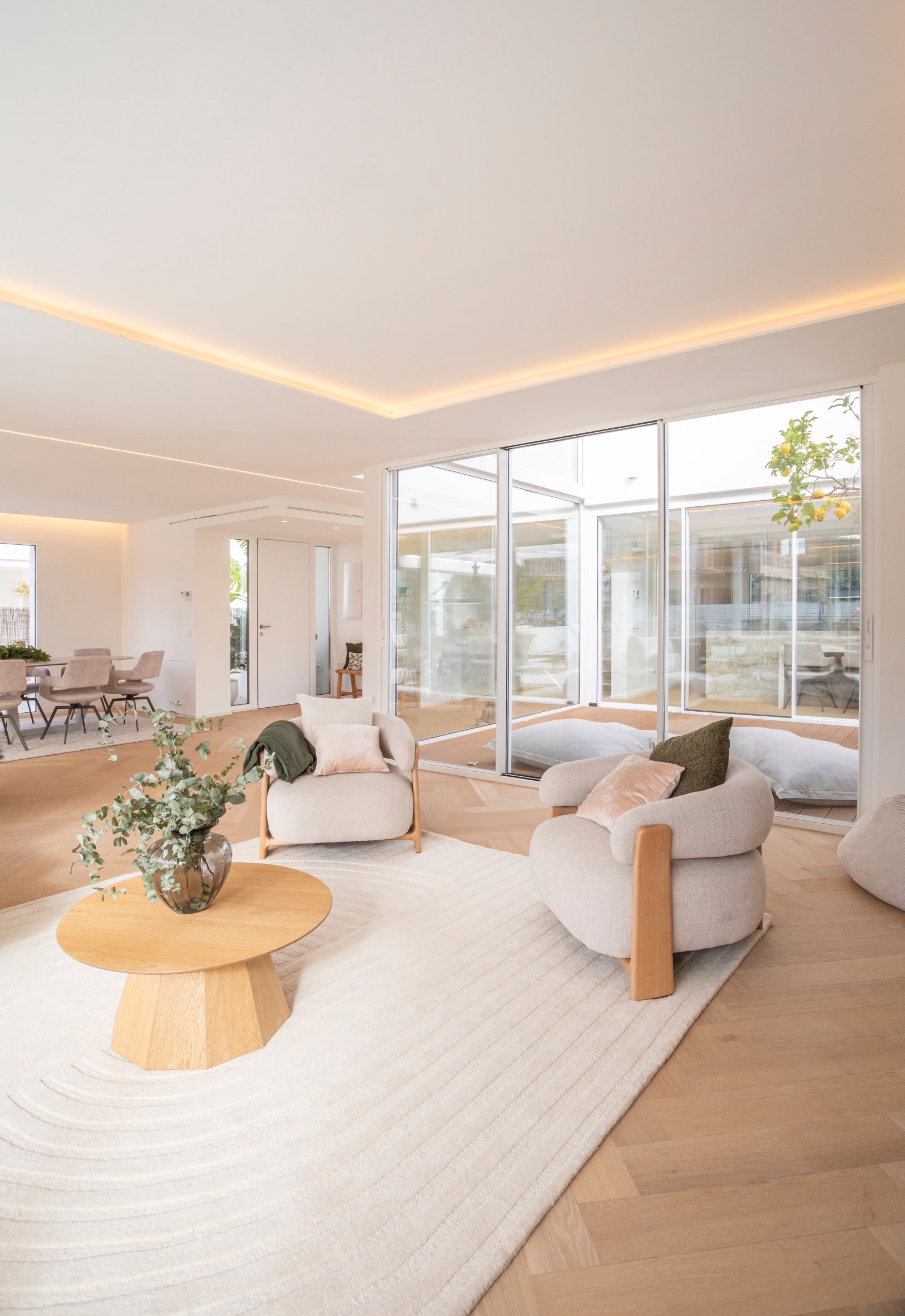 Bright living area with high-quality ceiling lighting and floor-to-ceiling glazing Bright living area with high-quality ceiling lighting and floor-to-ceiling glazing