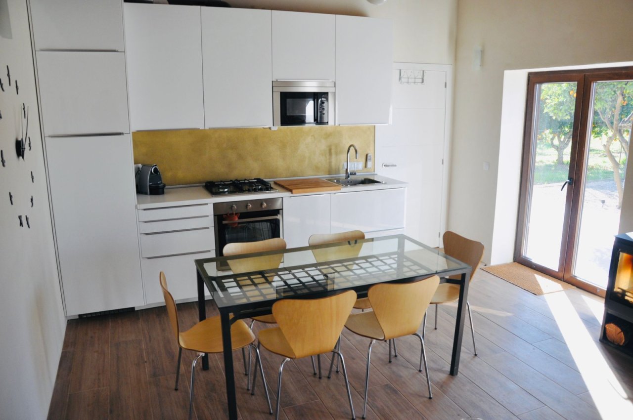 Modern open-plan kitchen with high-quality appliances and seamless transition to the dining area Modern open-plan kitchen with high-quality appliances and seamless transition to the dining area