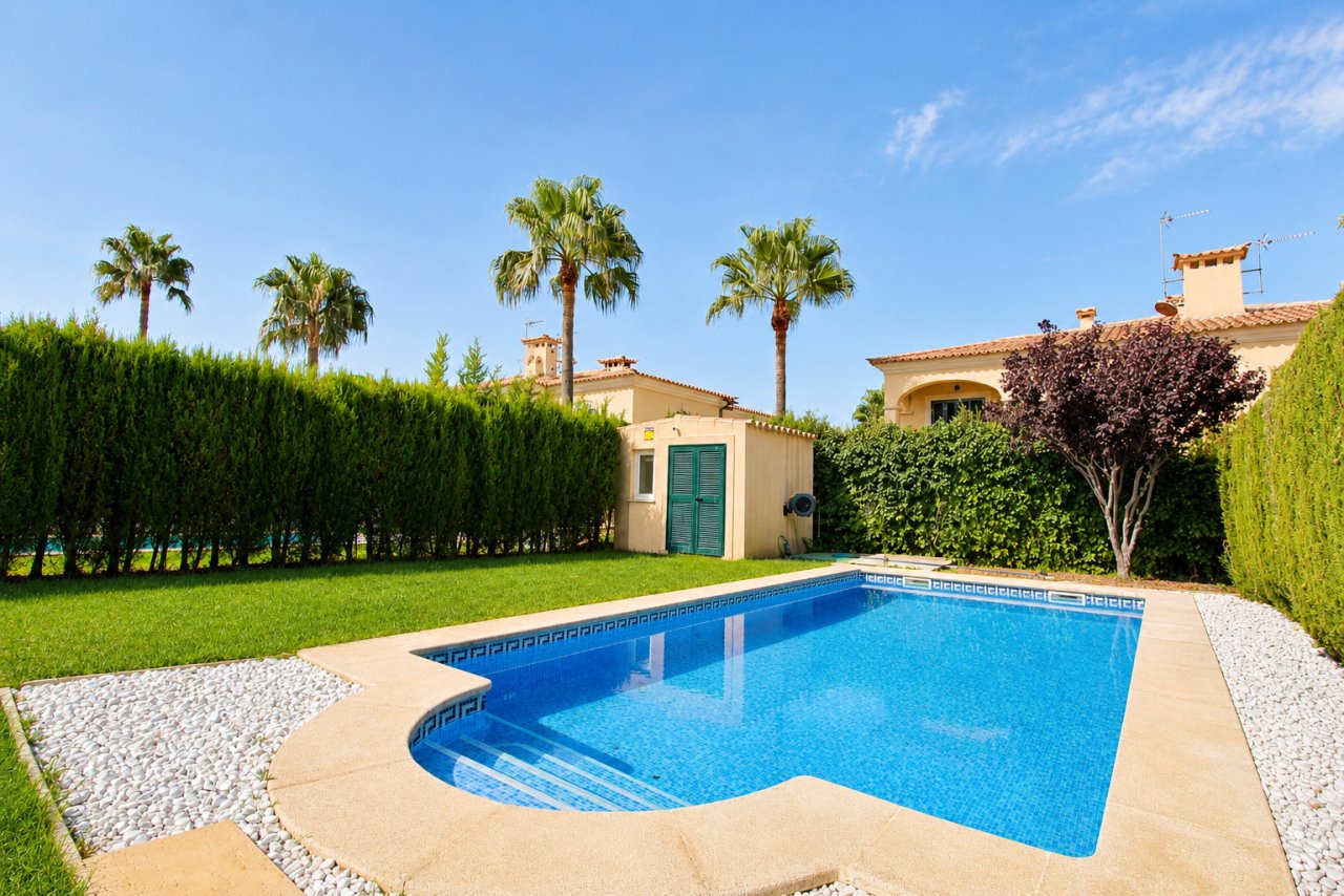 Private pool area with elegant terrace design and well-maintained garden ambiance