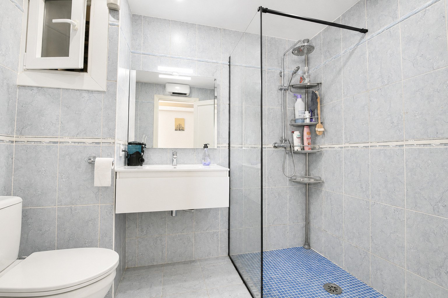 Modern bathroom with walk-in shower and practical storage integration