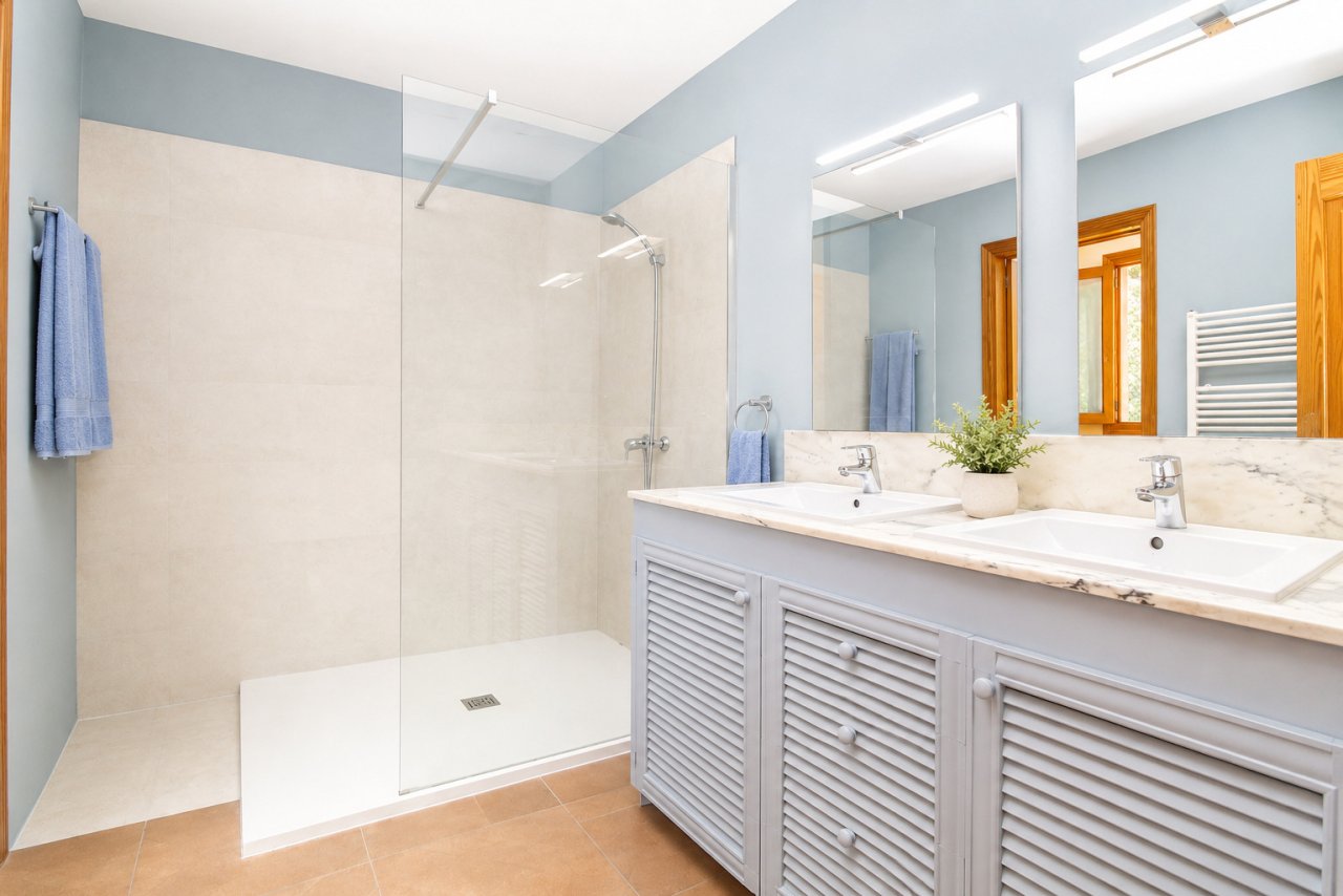 Modern bathroom with double vanity, walk-in shower, and large mirrors Modern bathroom with double vanity, walk-in shower, and large mirrors
