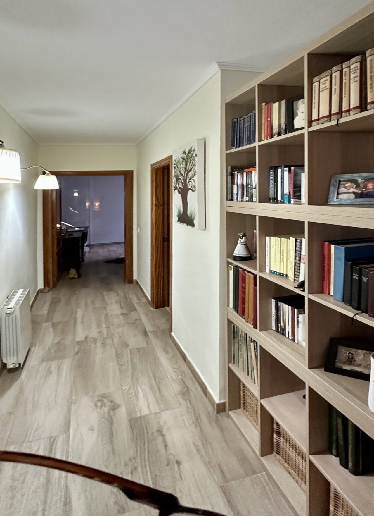 Hall with custom-built shelving walls and optimal space utilization