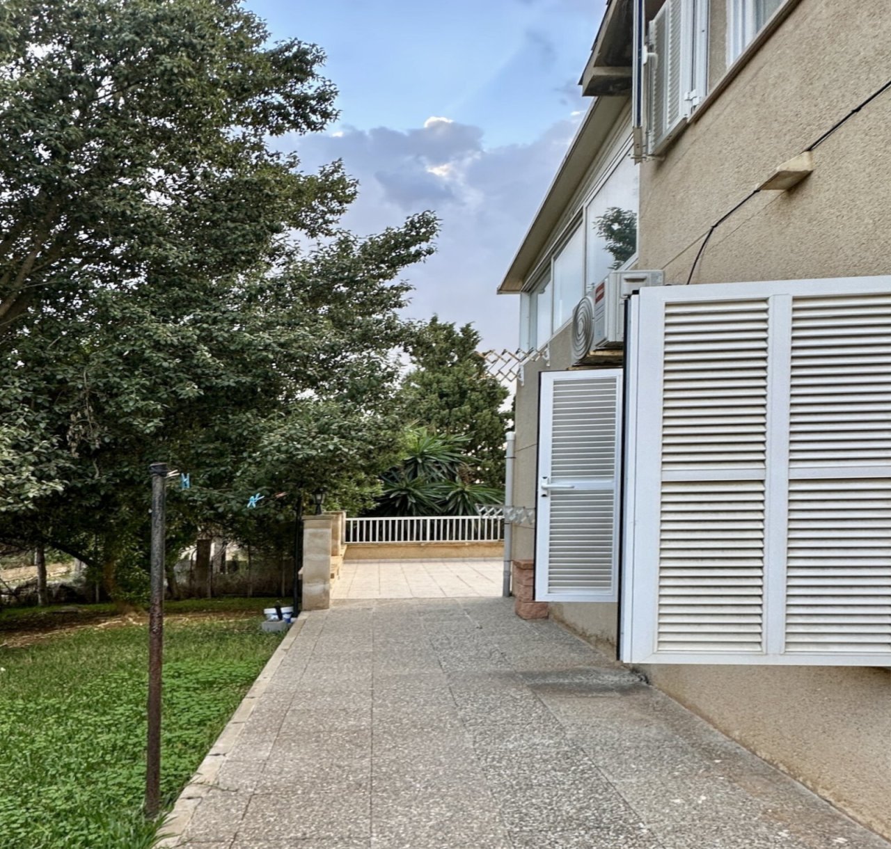 Well-maintained outdoor area with paved driveway and modern ventilation systems