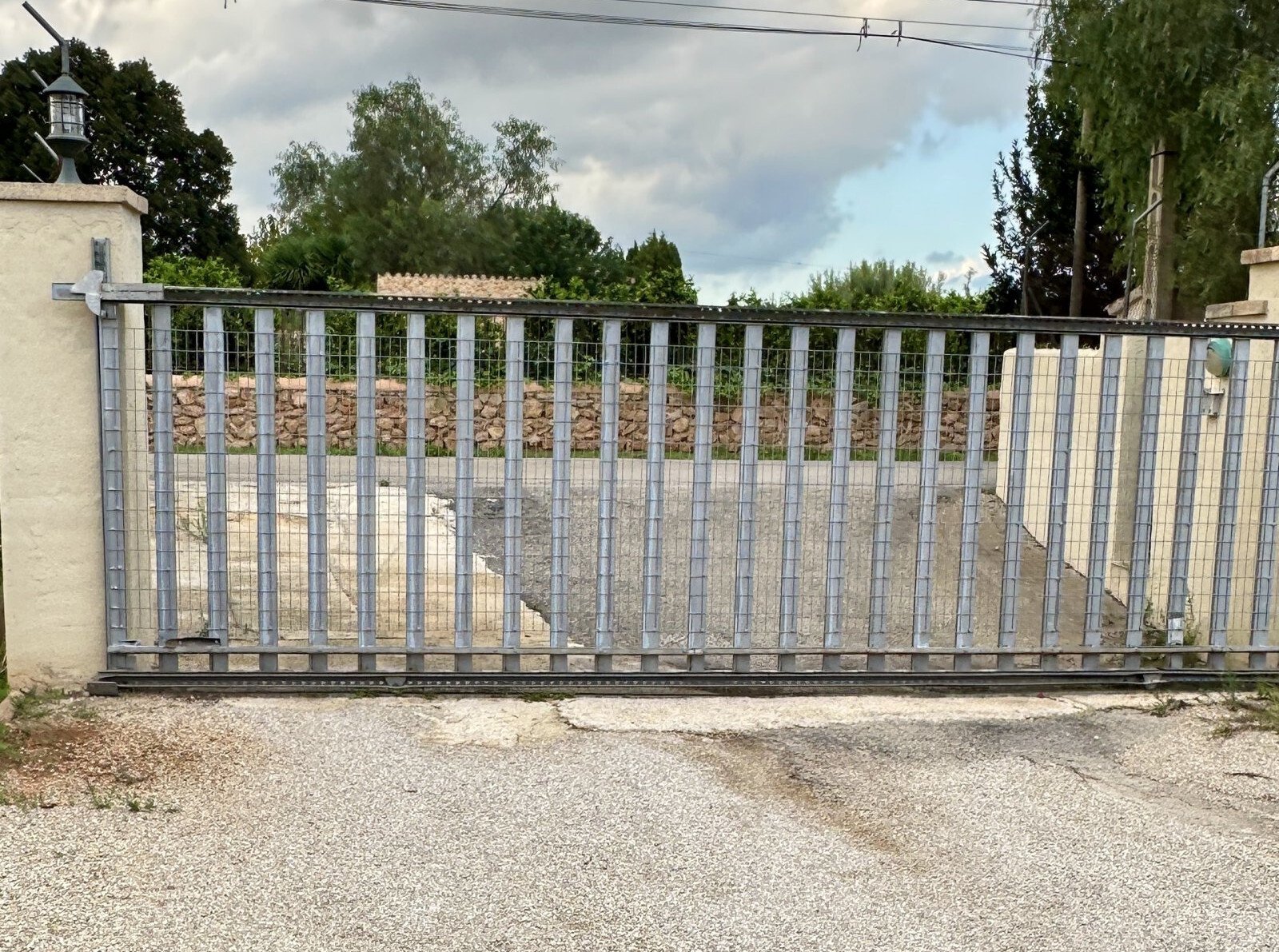 Secure entrance with automated sliding gate and sturdy metal construction