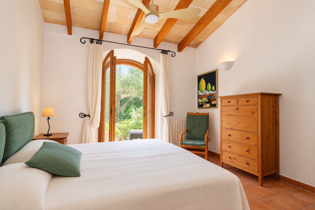 Bedroom with wooden beam ceiling and direct access to the terrace Bedroom with wooden beam ceiling and direct access to the terrace