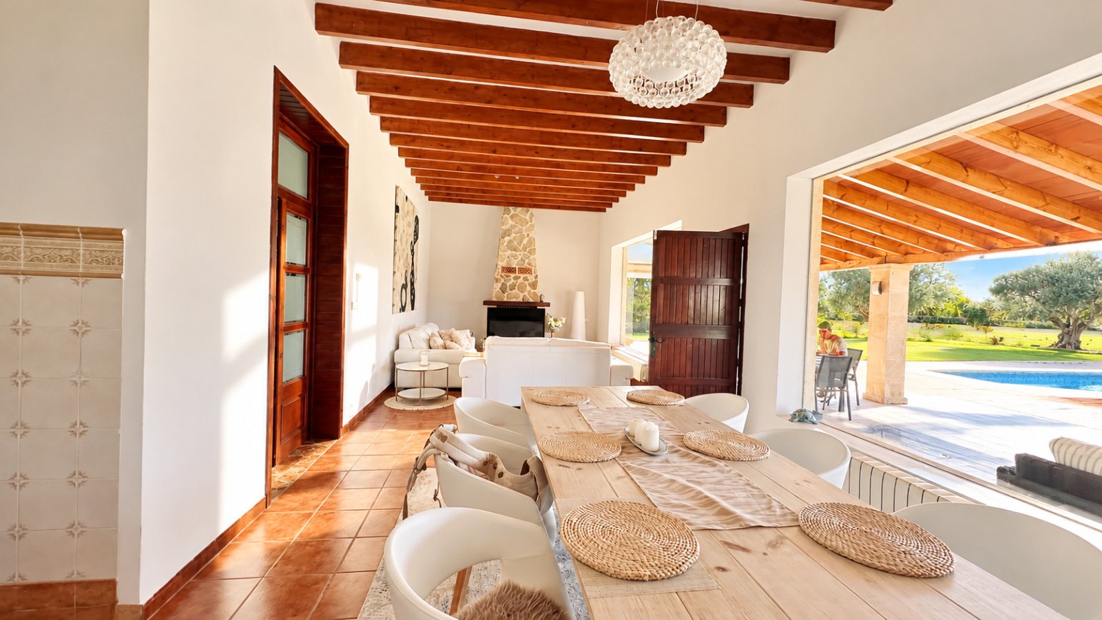 Bright living and dining area with open layout and high-quality wooden beam ceiling