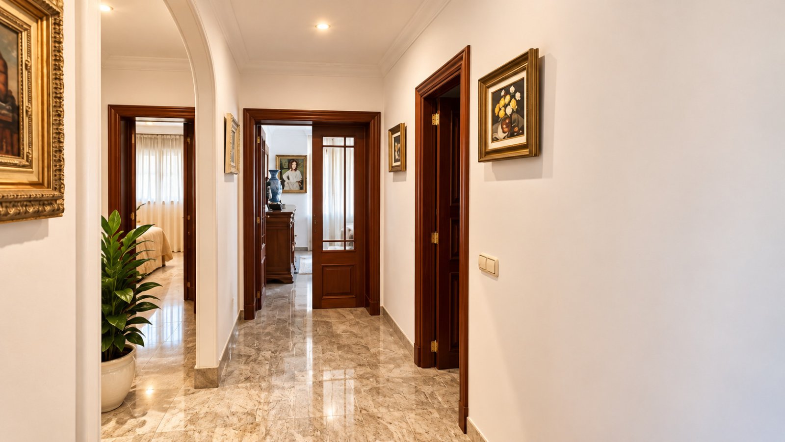 Elegant hallway with noble natural stone flooring and high-quality wooden doors