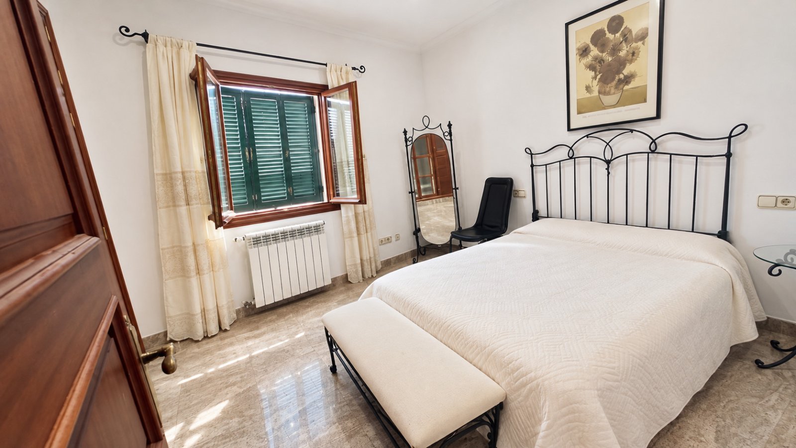 Bright bedroom with window front and comfortable layout