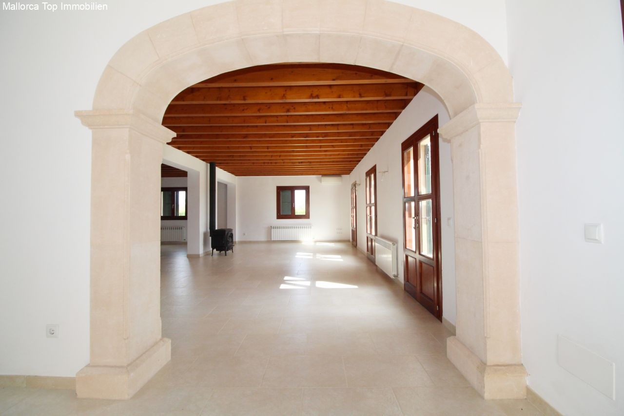 A characterful sequence of rooms with natural stone arches and a wooden beam ceiling