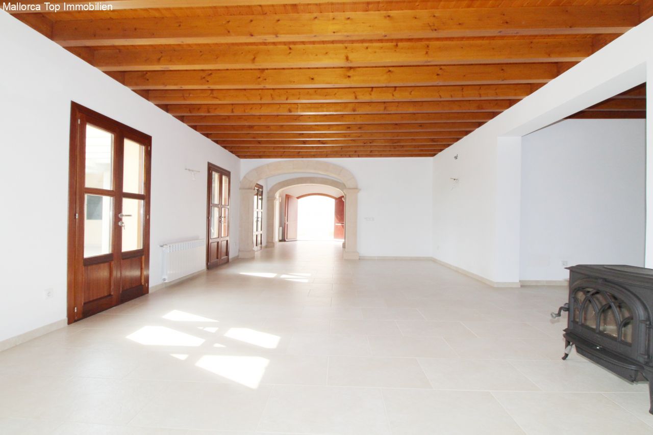 Open space layout with wooden beam ceiling and elegant natural stone arches