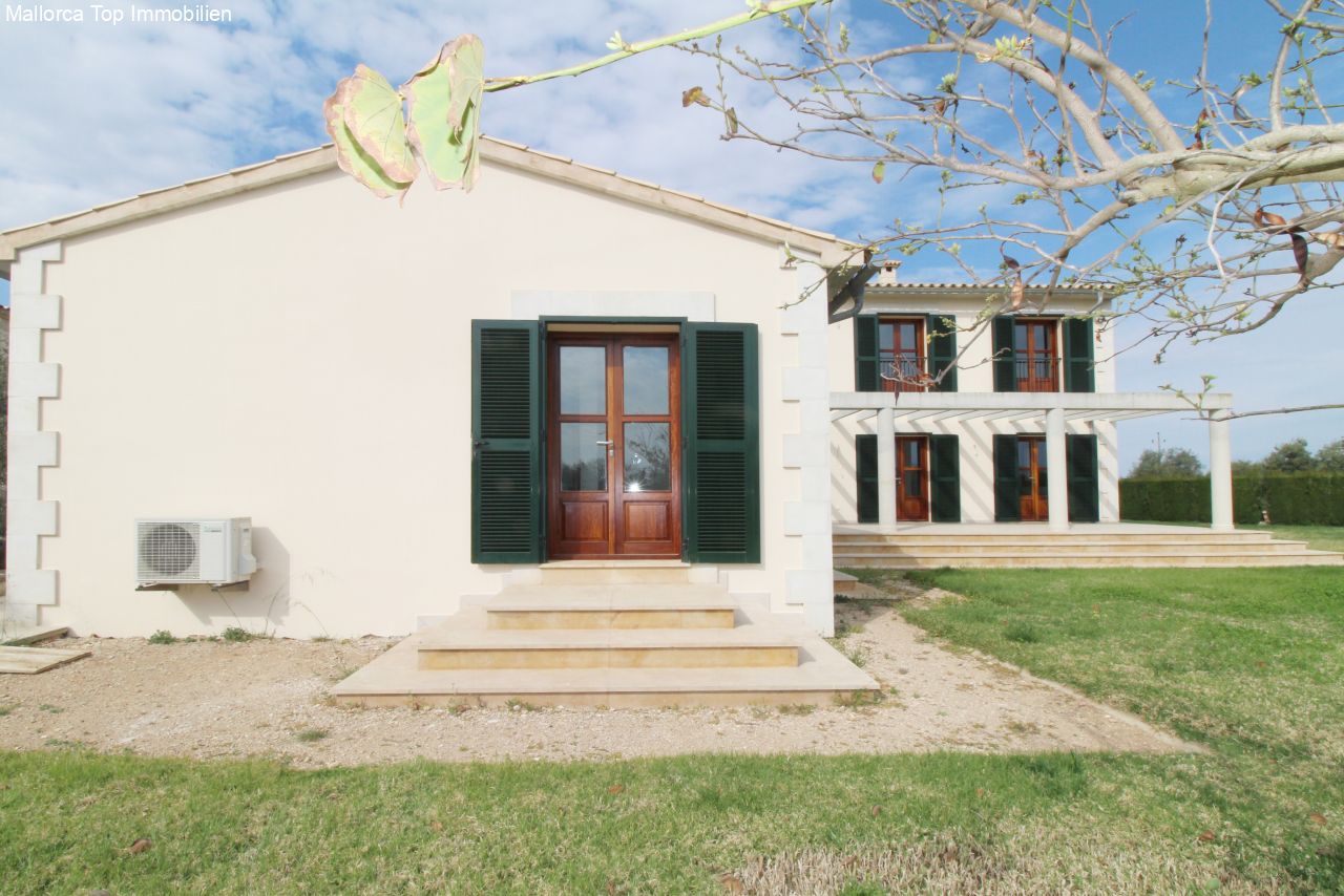 Classic facade with green shutters and an elegant entrance staircase