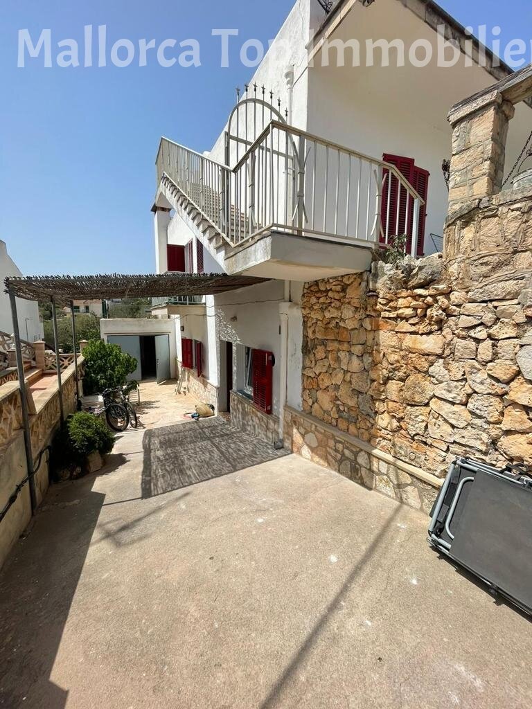 Paved courtyard with elegant metal staircase and pergola roof Paved courtyard with elegant metal staircase and pergola roof