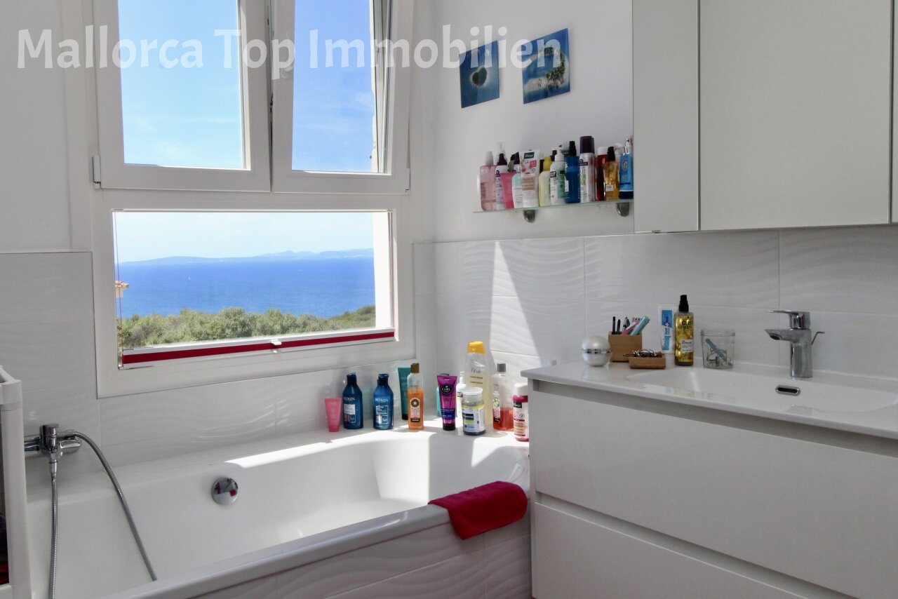 Bathroom with panoramic sea window and smart storage solution Bathroom with panoramic sea window and smart storage solution