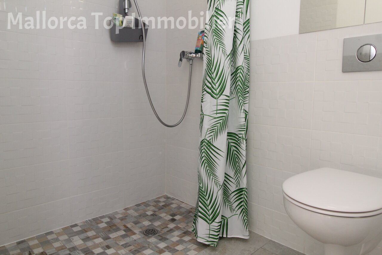 Modern bathroom with walk-in shower and practical amenities Modern bathroom with walk-in shower and practical amenities