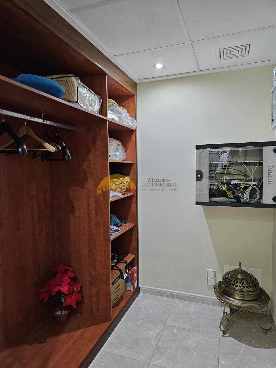 Walk-in dressing room with custom-made wooden wardrobe system and intelligent storage organization Walk-in dressing room with custom-made wooden wardrobe system and intelligent storage organization