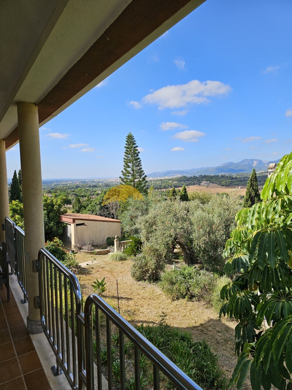 Covered gallery with stainless steel railing and unobstructed view of the estate Covered gallery with stainless steel railing and unobstructed view of the estate