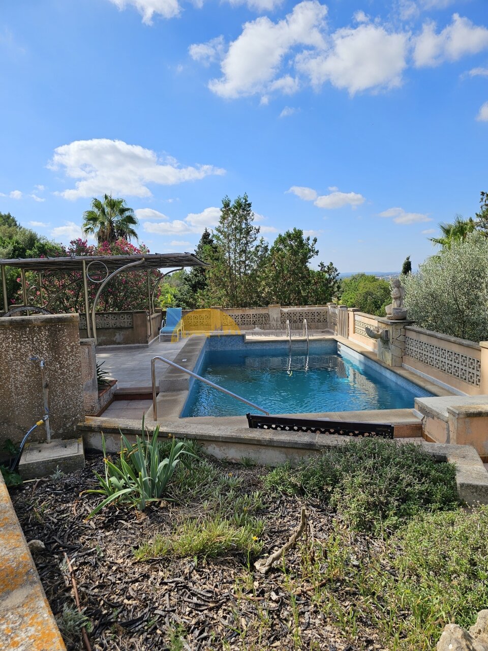 Luxurious pool area with surrounding terrace and distant view Luxurious pool area with surrounding terrace and distant view