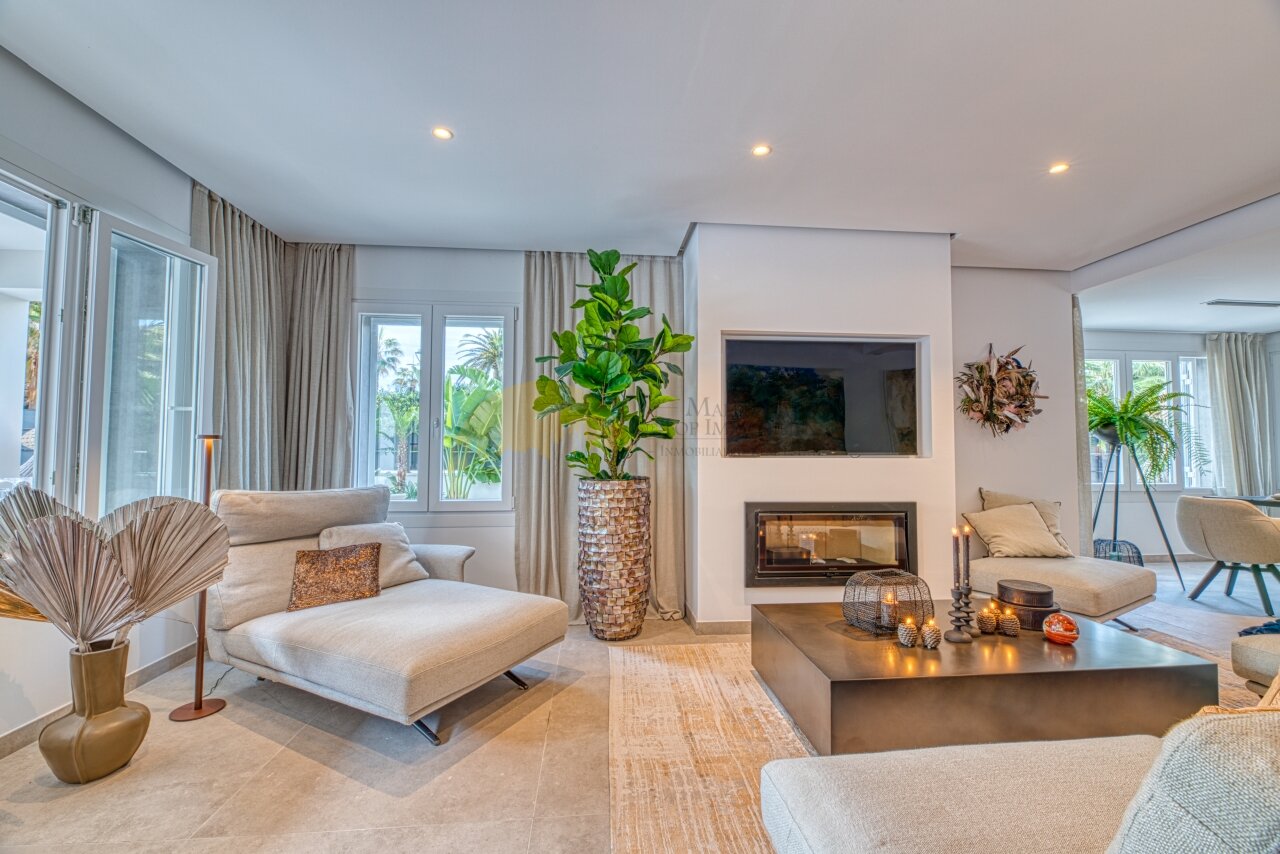Elegant living room with fireplace, built-in TV, and large terrace access