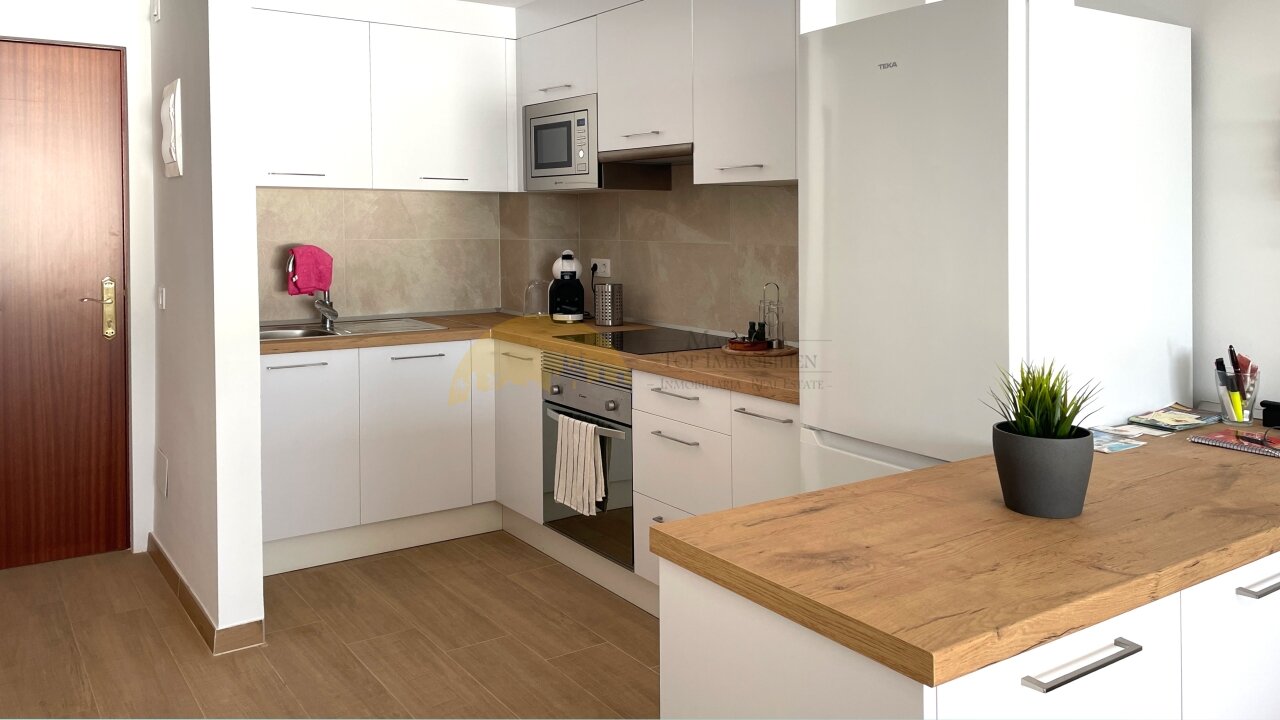 Modern kitchen unit with a practical island counter and high-quality built-in appliances Modern kitchen unit with a practical island counter and high-quality built-in appliances