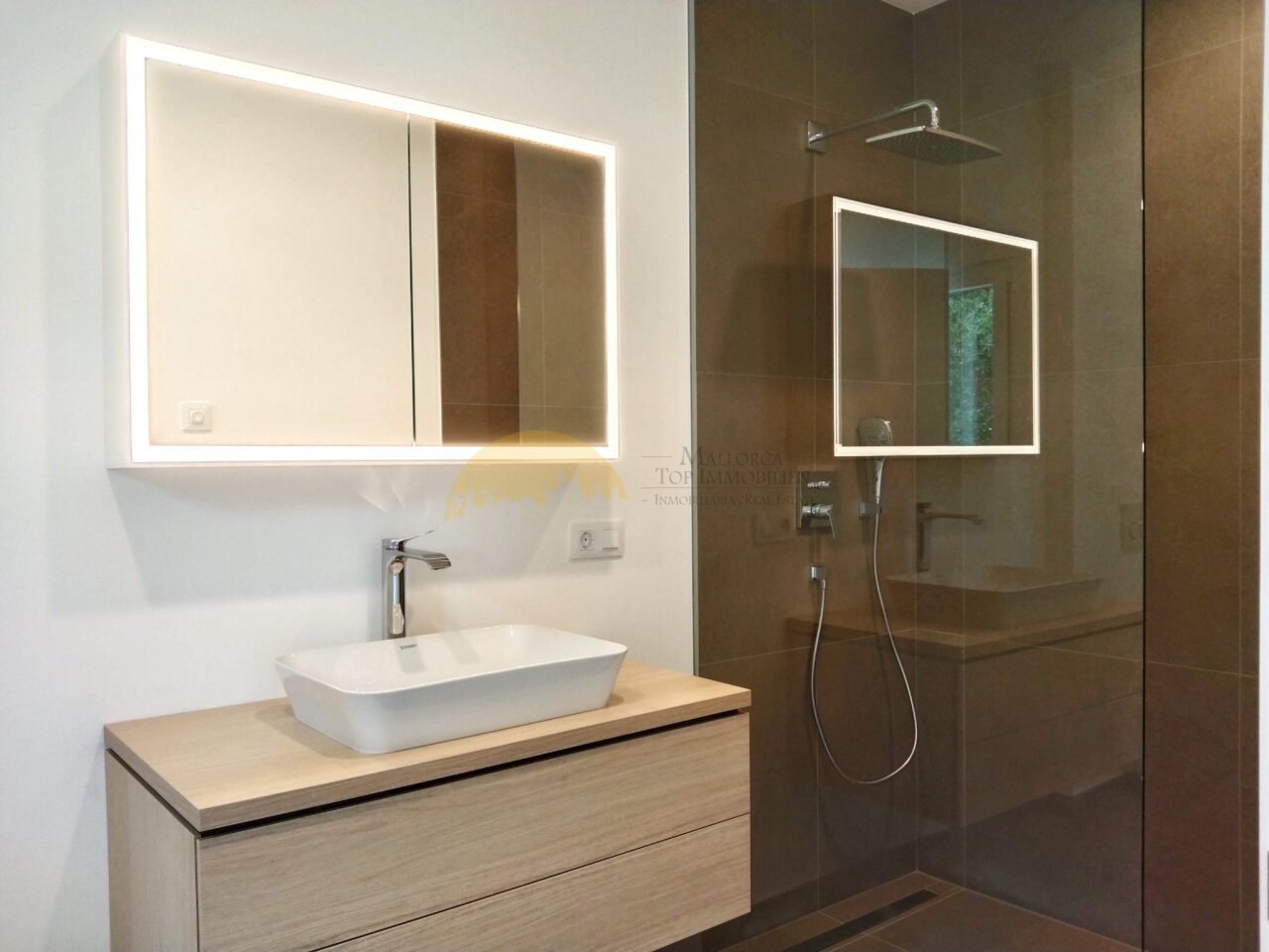 Modern bathroom with LED mirrors and walk-in shower Modern bathroom with LED mirrors and walk-in shower