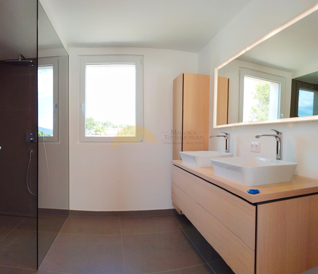 Luxurious bathroom with double washbasin and panoramic windows Luxurious bathroom with double washbasin and panoramic windows
