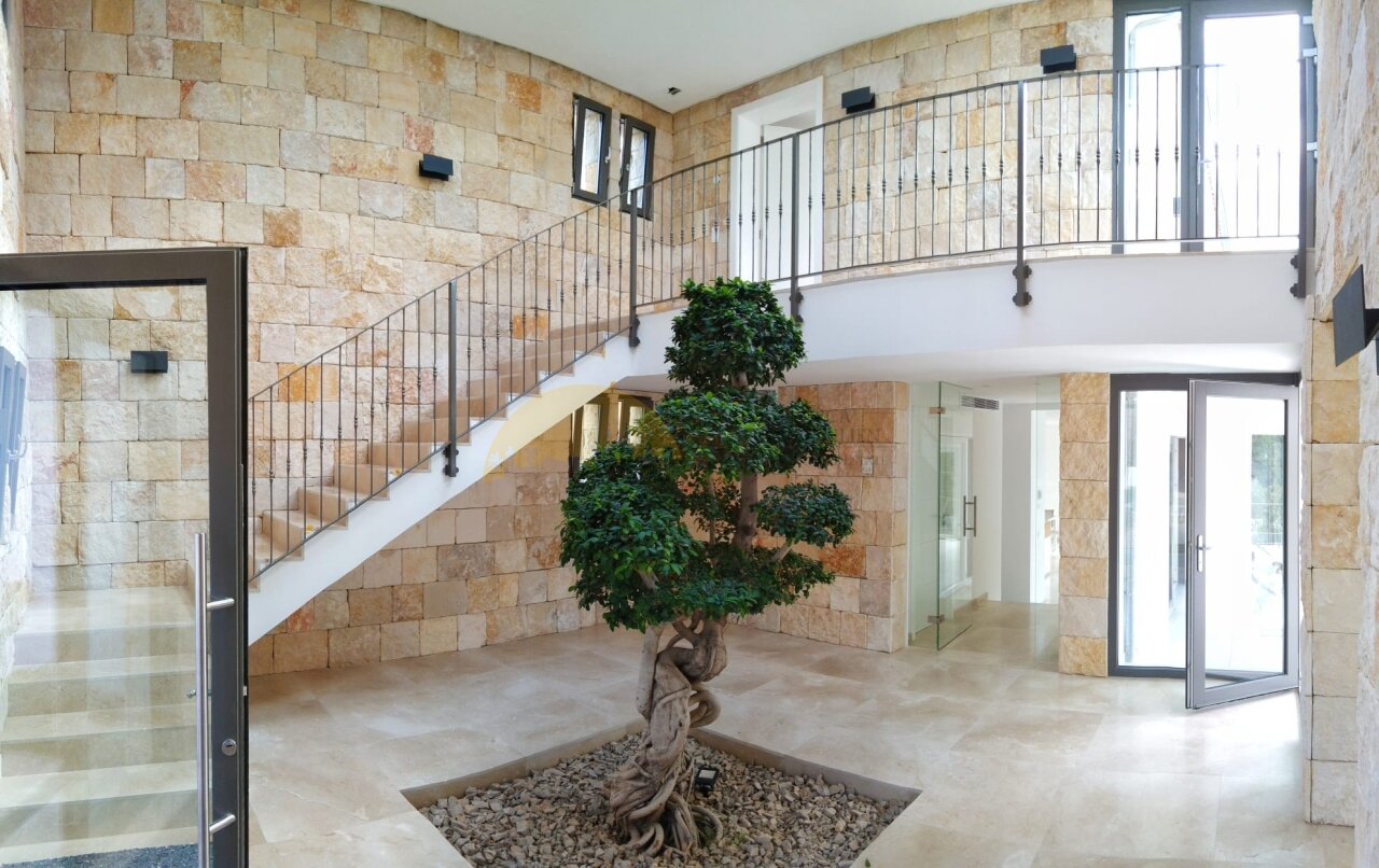 Impressive entrance hall with a double-story staircase and large glass surfaces Impressive entrance hall with a double-story staircase and large glass surfaces