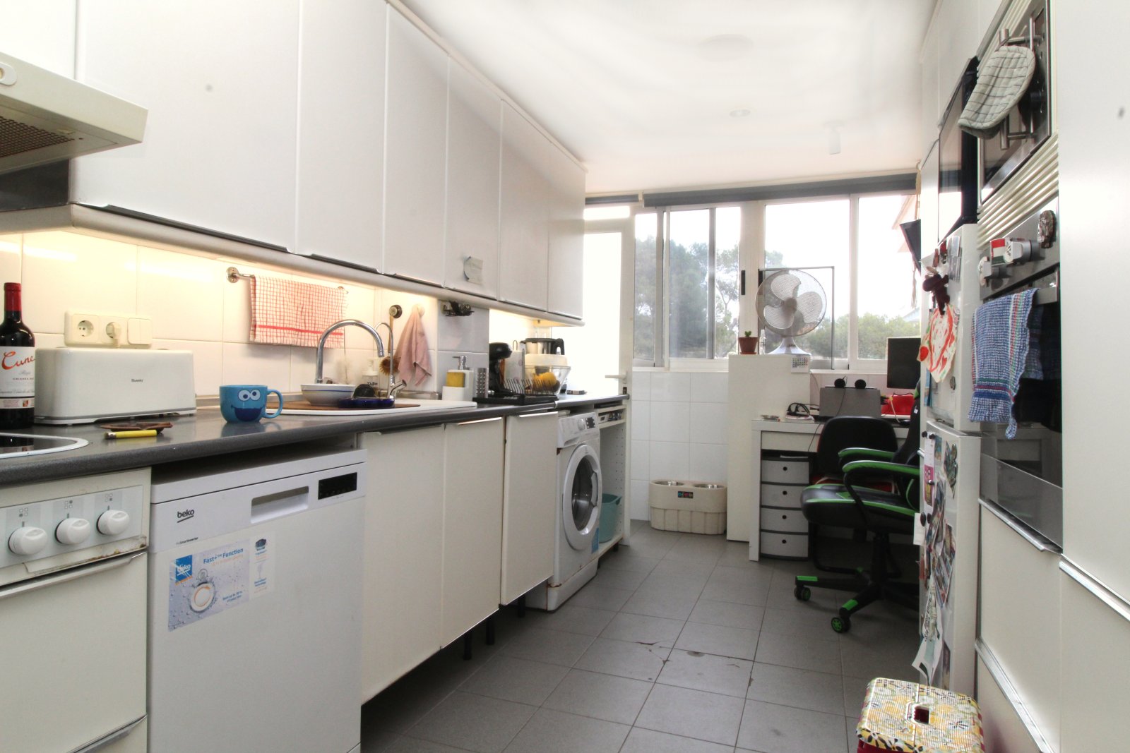 Modern kitchen with practical layout and extensive appliance equipment Modern kitchen with practical layout and extensive appliance equipment