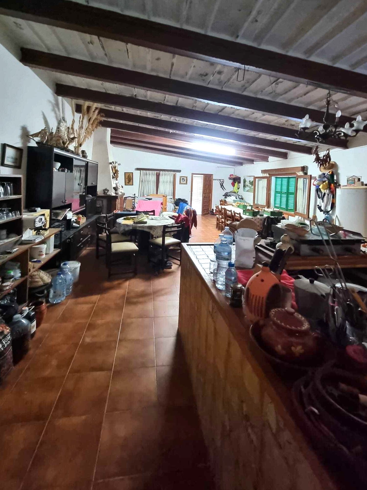 Open living area with distinctive ceiling beams and versatile uses Open living area with distinctive ceiling beams and versatile uses