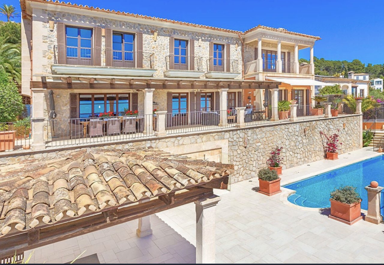 Elegant pool terrace with high-quality natural stonework and covered lounge area