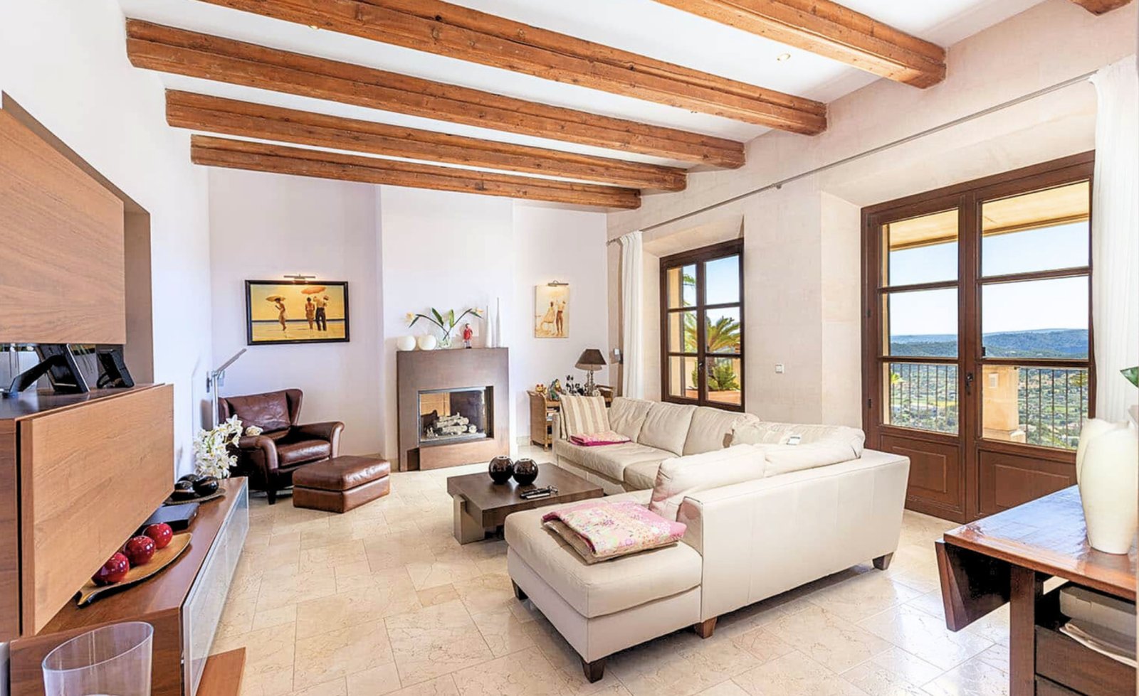 Living room with characterful wooden beams and direct access to the panoramic terrace