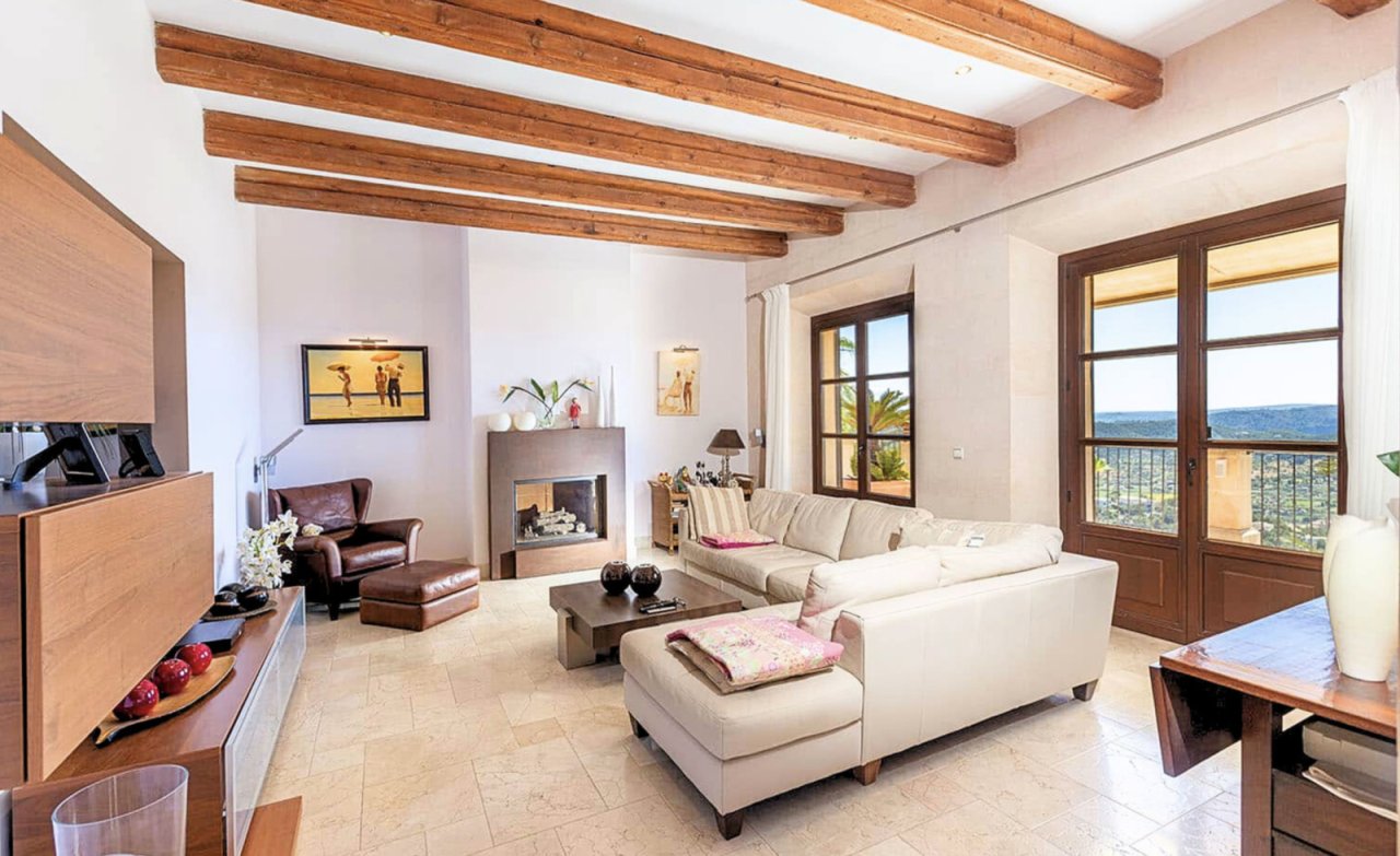 Living room with characterful wooden beams and direct access to the panoramic terrace