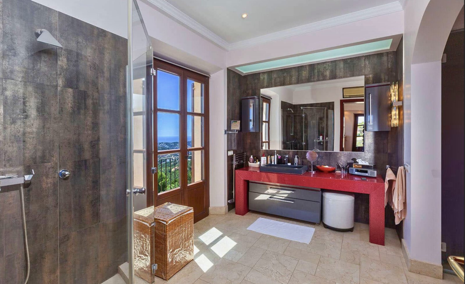 Luxury bathroom with freestanding tub, walk-in shower, and panoramic sea view