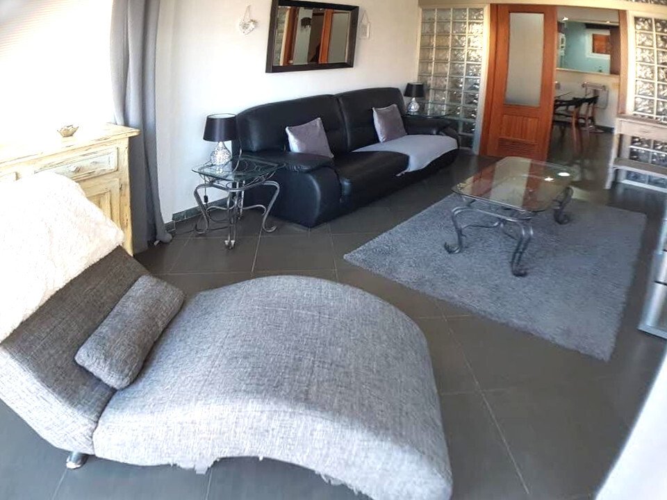 Open living room with flowing space transitions and glass sliding doors Open living room with flowing space transitions and glass sliding doors