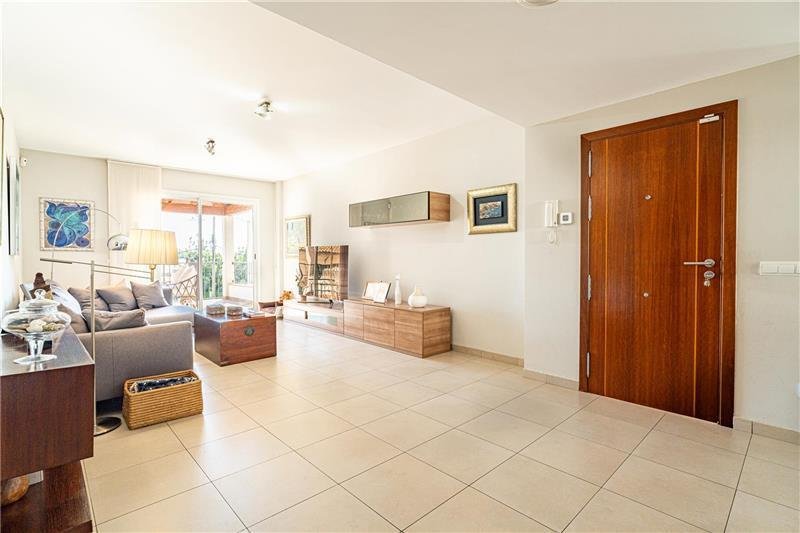 Bright living room with direct access to the terrace and high-quality materials.