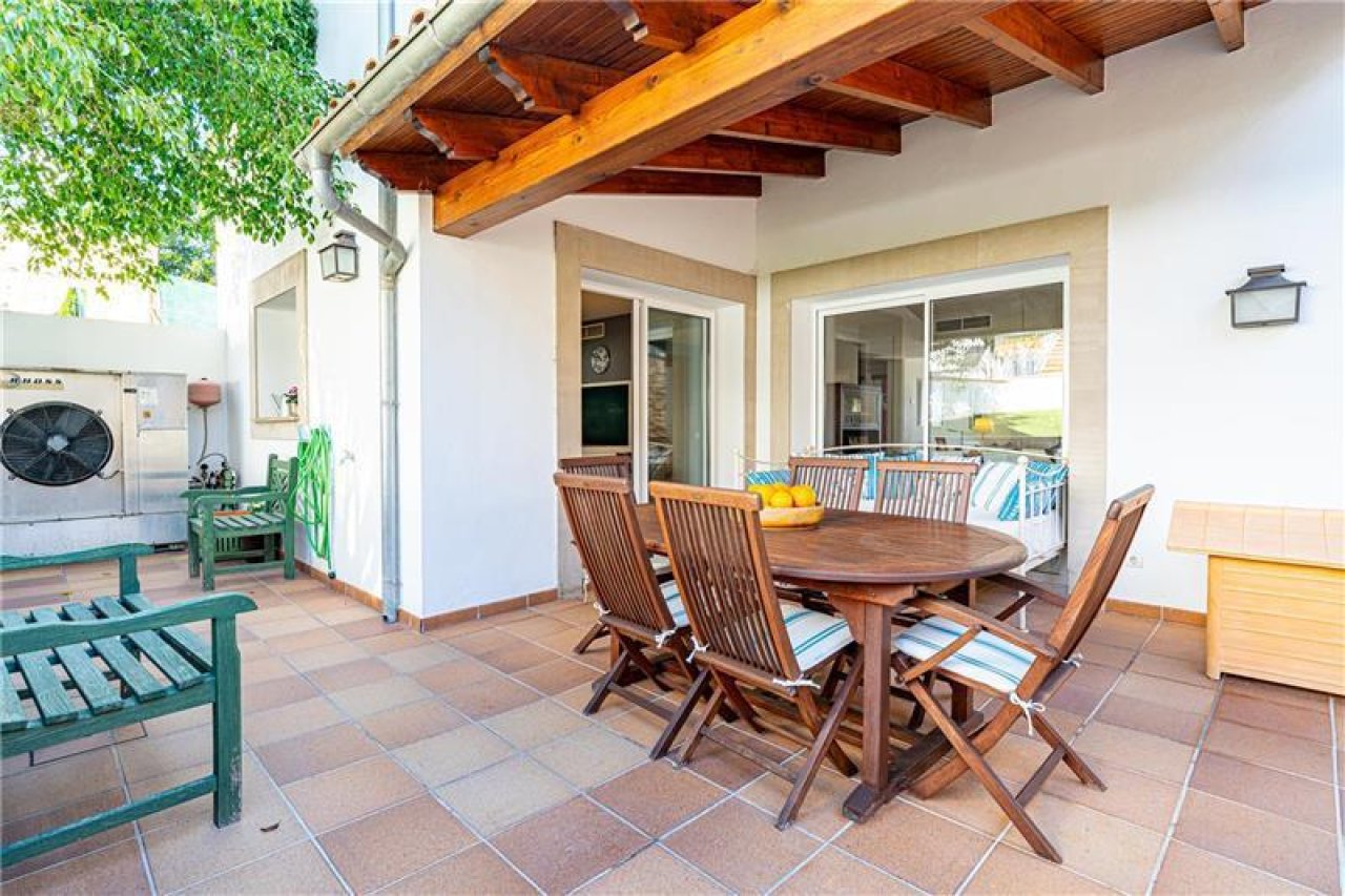 Covered terrace with solid wooden beams and direct access to the living area