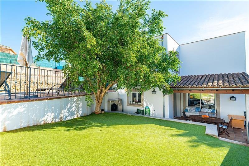 Private garden with shady trees and direct terrace access