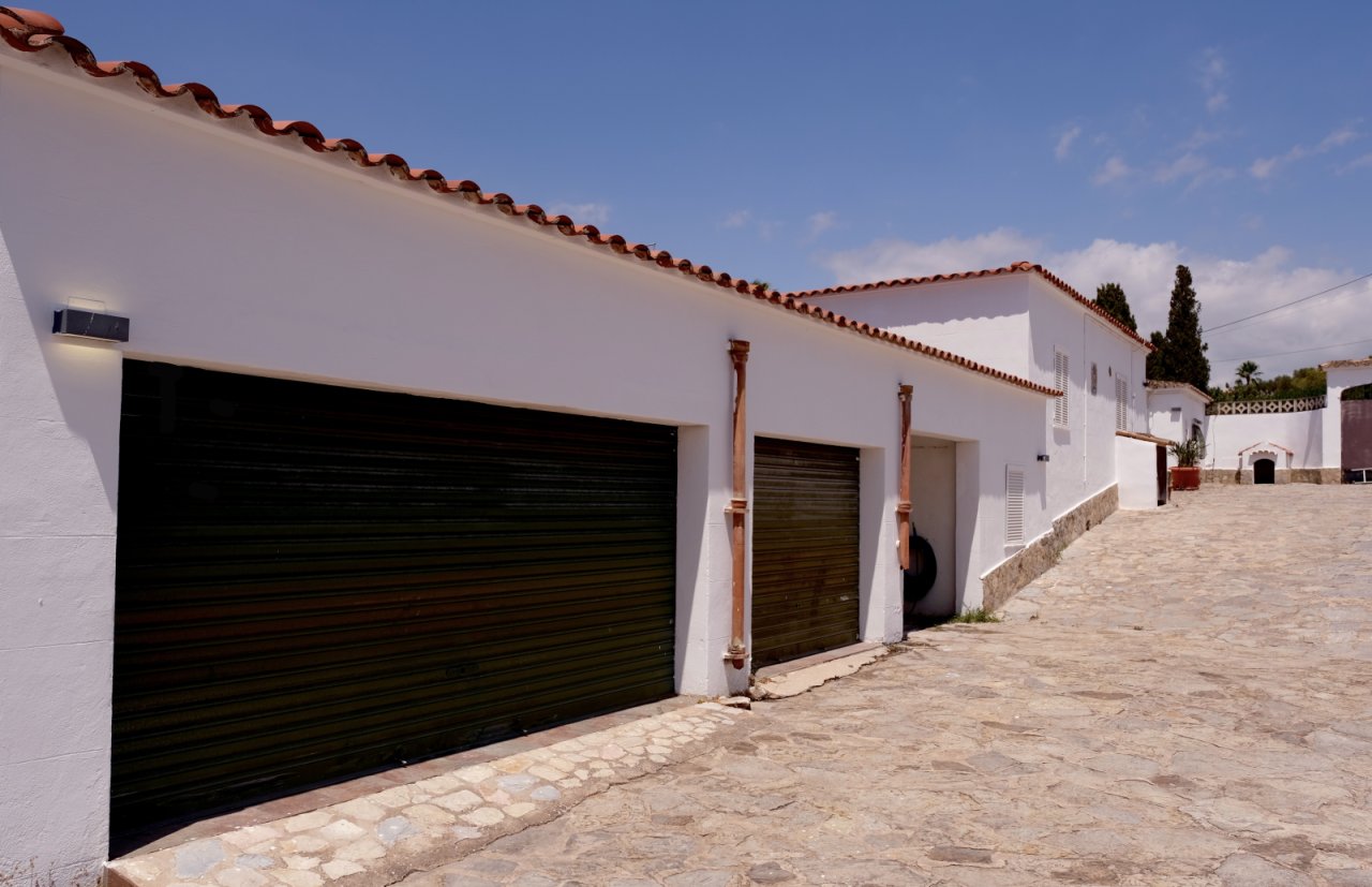 Practical double garage with retractable roller door systems and paved forecourt