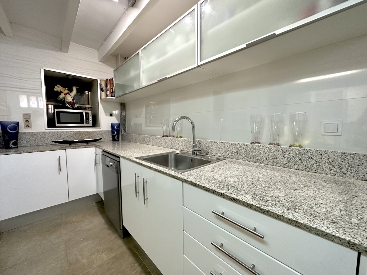 Modern kitchen with granite countertop and practical storage solution