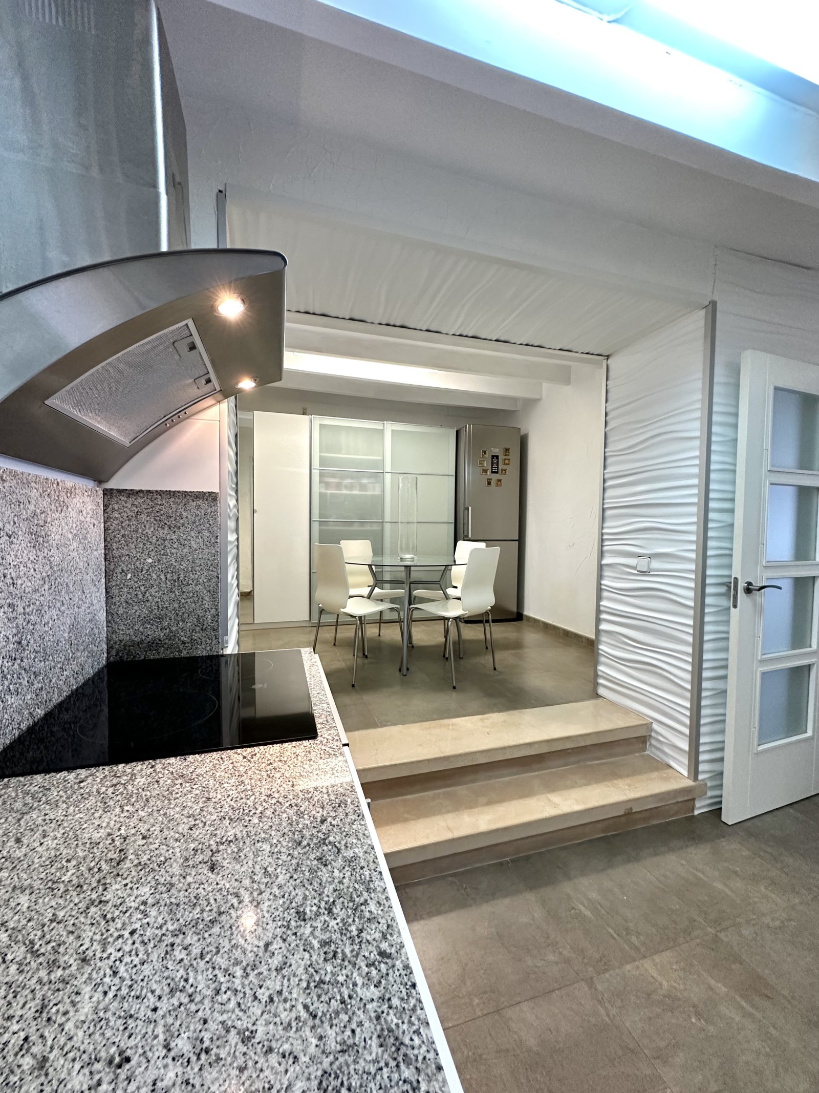 Modern open-plan kitchen with seamless room connection and high-quality granite countertop