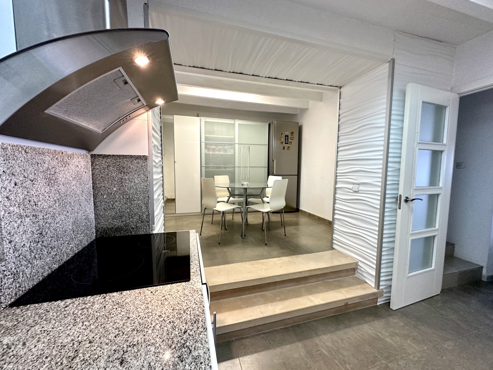 Open kitchen with seamless transitions and high-quality kitchen equipment